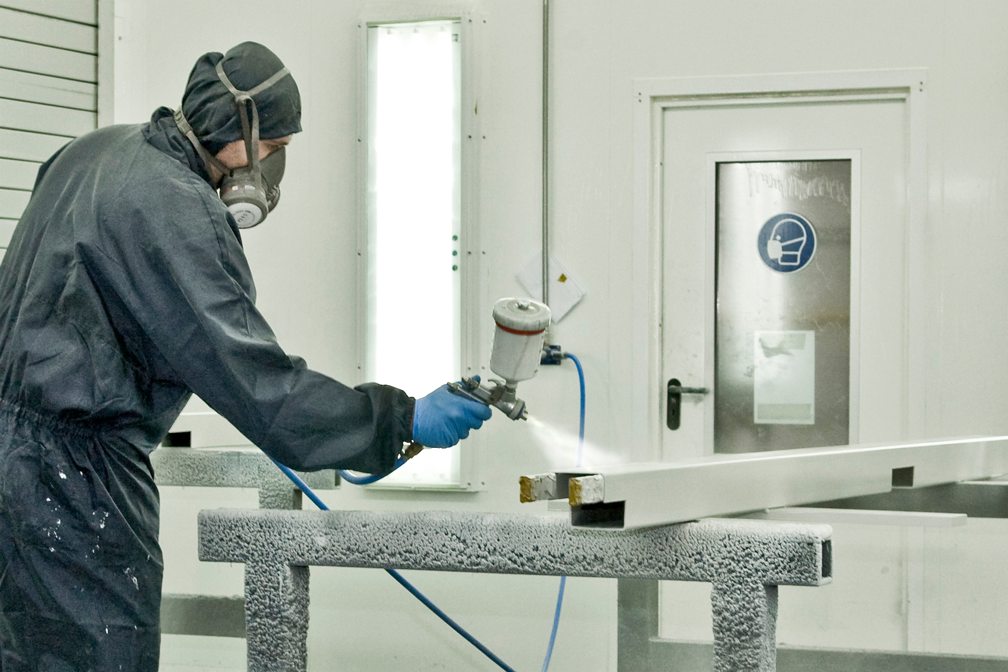 A guy is powder coating