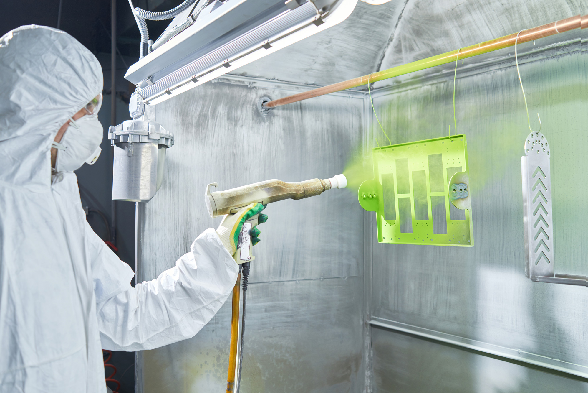 A guy varnishes a Metal piece