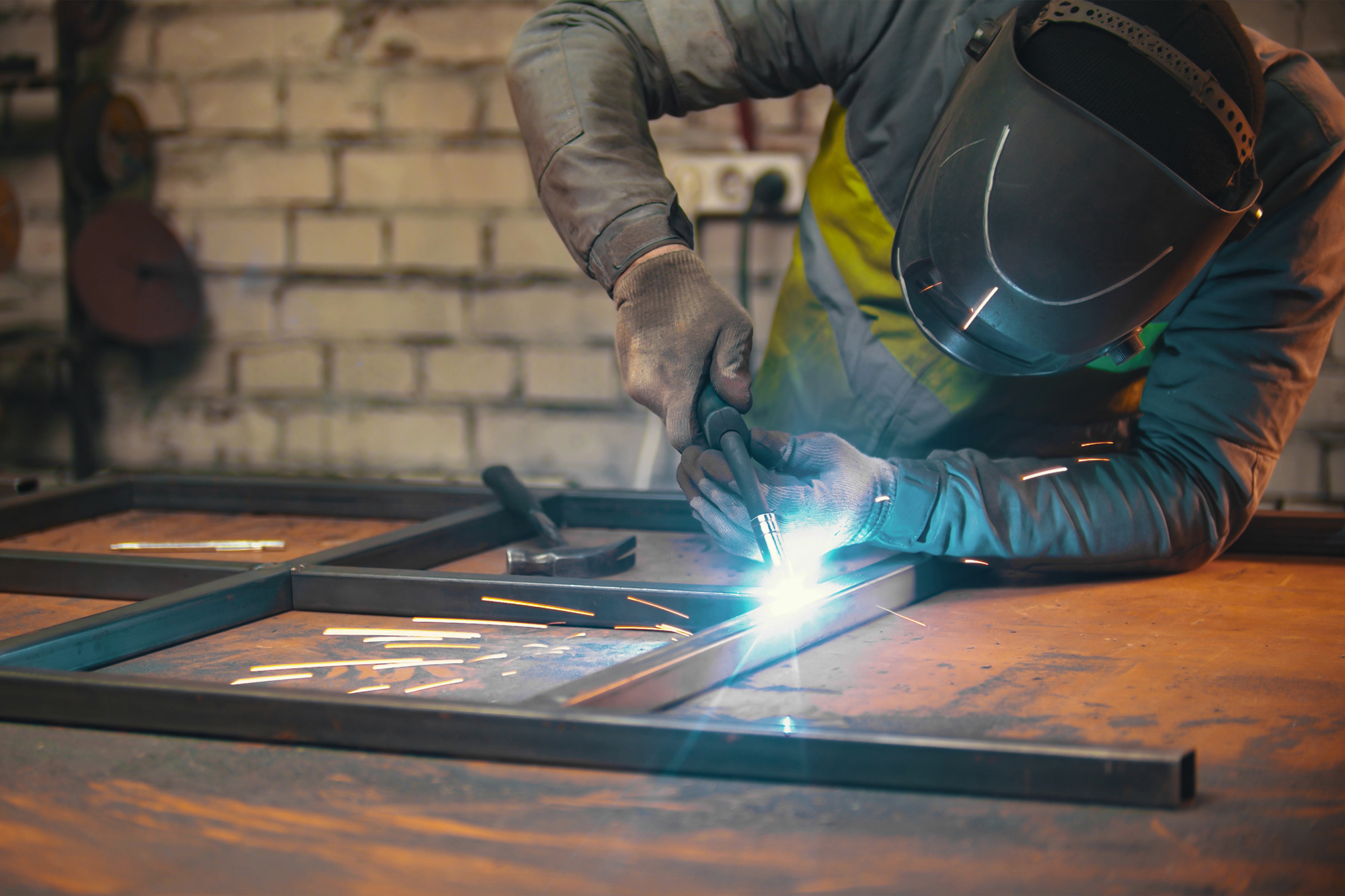 Guy welding metal together
